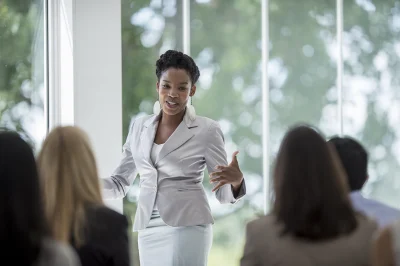 professional woman giving talk to participants